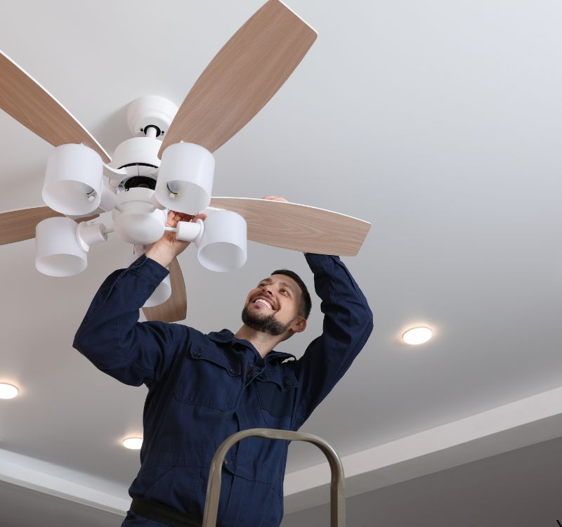 Electrician installing a new ceiling fan