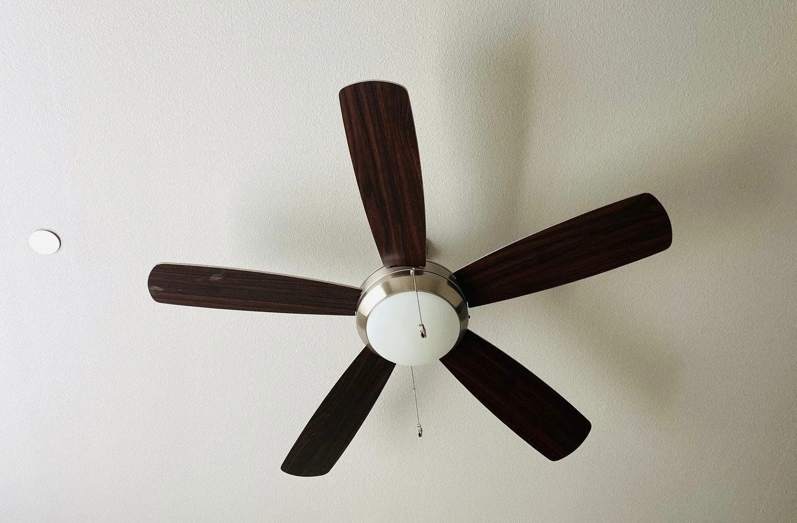 Electrician checking ceiling structure before a ceiling fan installation