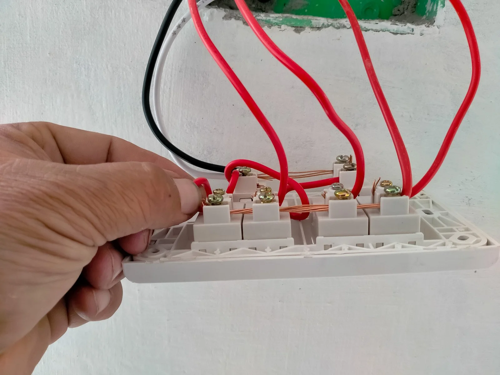 Electrician fitting an electrical switch in a home