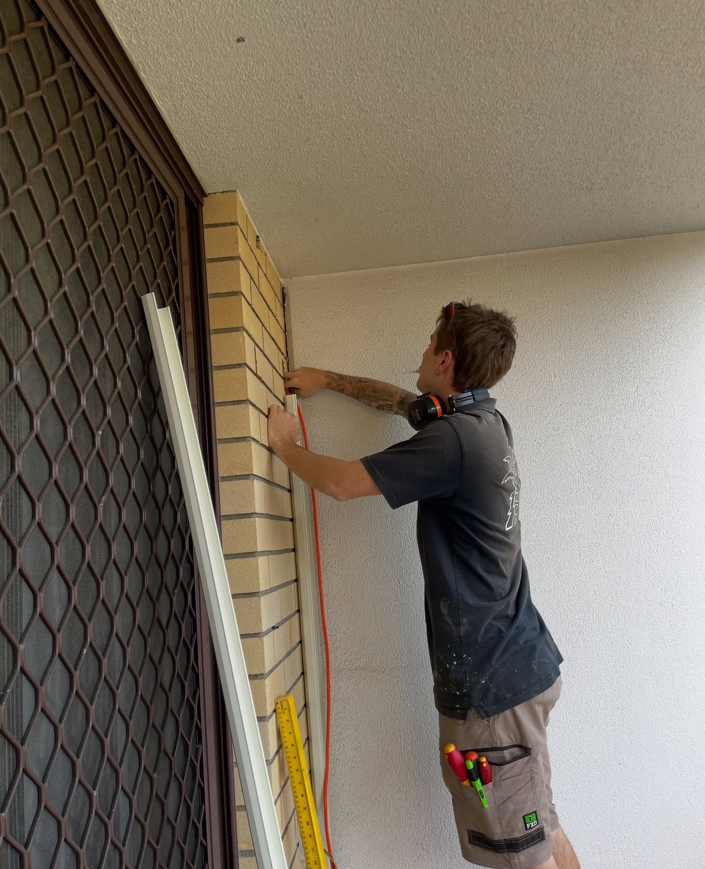 Electrician installing interior lighting at a Southern Gold Coast home
