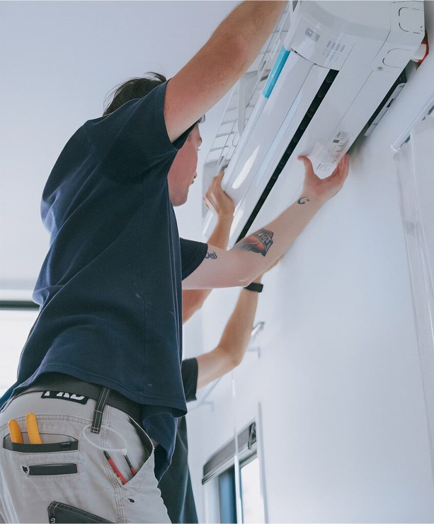 HUX electrician mounting a split system air con unit