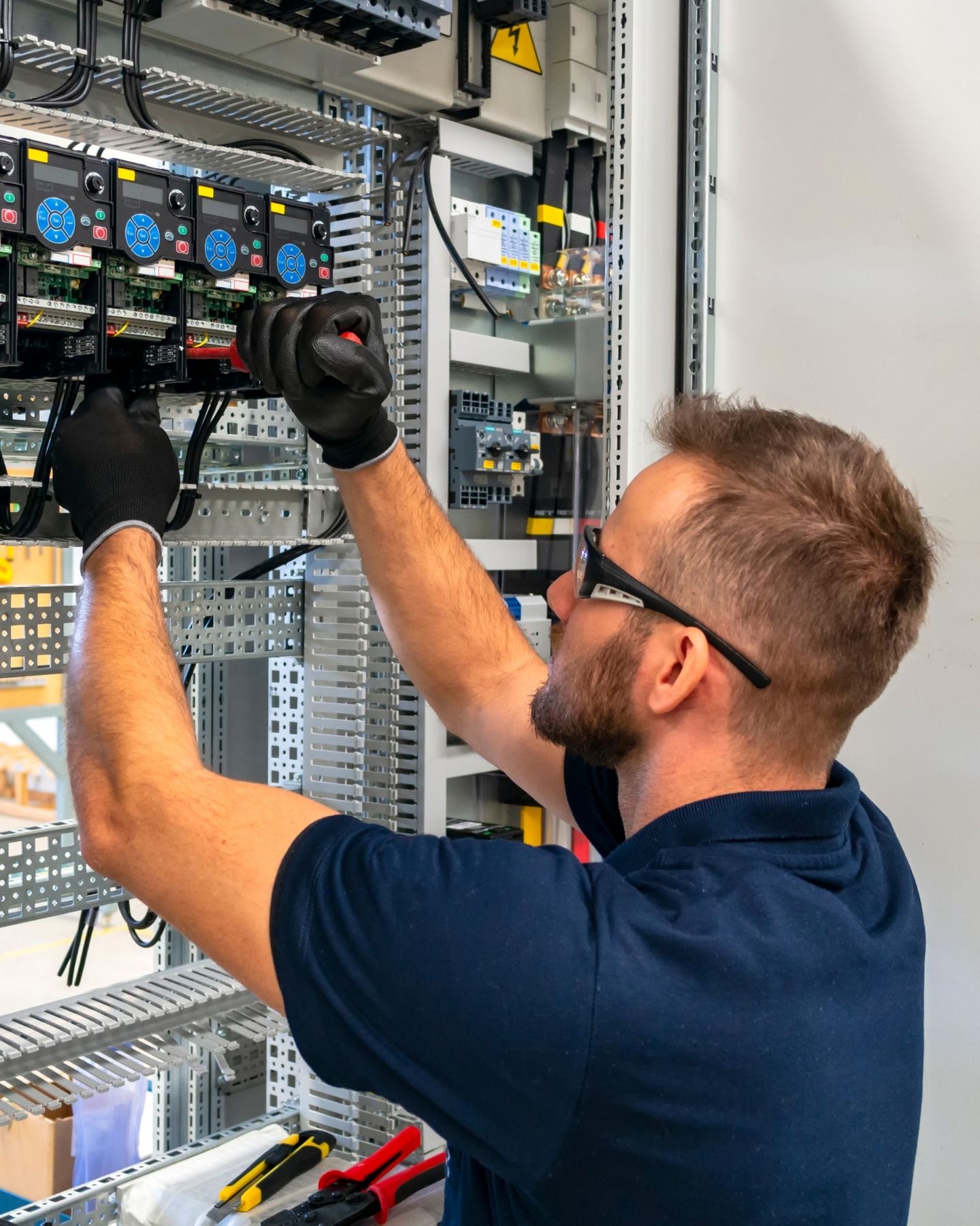 HUX electrician repairing a switchboard fault on an emergency job